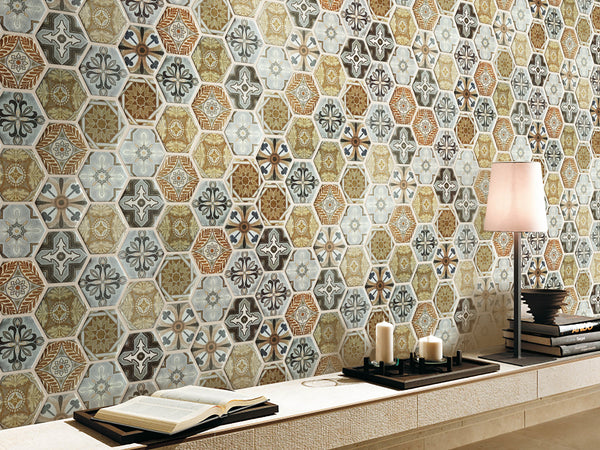 A wall featuring hexagon-shaped glass mosaic tiles with a satin finish and multicolored patterns, resembling designs inspired by Moroccan markets.