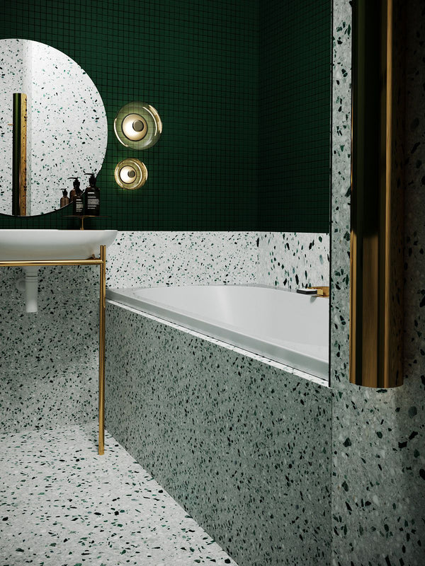 Modern bathroom with green walls, white bathtub, and gold fixtures.