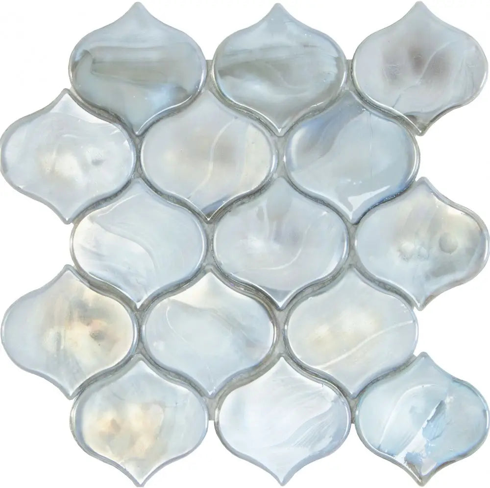 Mosaic tile pattern with shell-like shapes on a white background