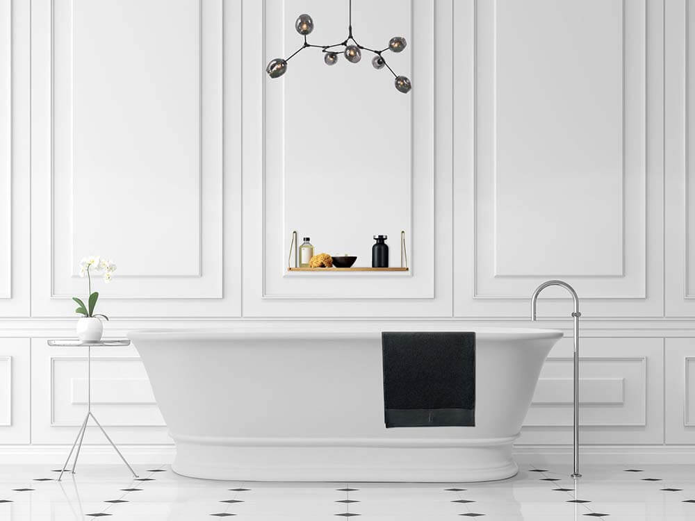 Modern bathroom with a freestanding bathtub, decorative wall mirror, and stylish lighting fixture.
