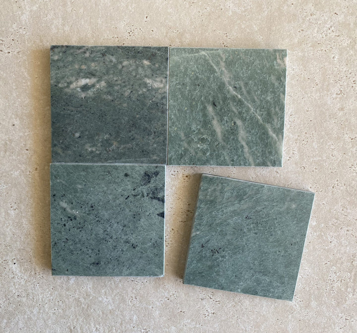 Marble natural stone tiles with elegant veining patterns in white, beige, and grey tones