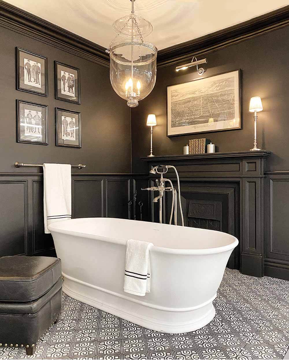Stylish bathroom with freestanding bathtub, dark walls, and decorative elements.